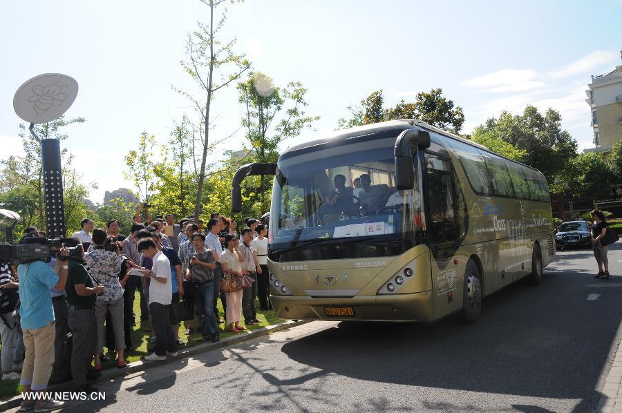 The victims' families of Asiana Airlines crash get on the bus to Shanghai Pudong Airport, in Quzhou city, east China's Zhejiang Province, July 8, 2013. The victims' families of Asiana Airlines' crash prepared to fly to the U.S. to deal with the aftermath of the crash Monday morning. (Xinhua/Huang Shuifu)