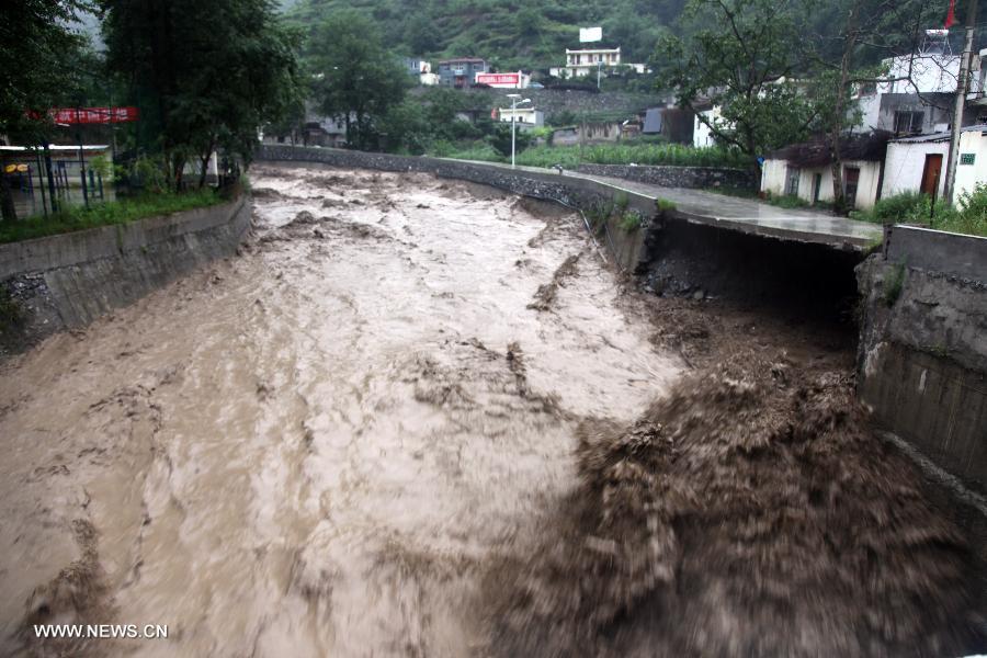 A road is destroyed by rainstorm-triggered flood at Yanmen Township in Wenchuan County, southwest China's Sichuan Province, July 10, 2013. Rainstorms battered the county in these two days. (Xinhua/Lu Guotong)