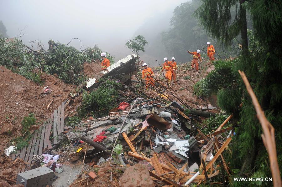 Fire fighters search for survivors after a mudslide at the Sanxi Village, in Dujiangyan City, southwest China's Sichuan Province, July 11, 2013. As of 2:10 p.m. Thursday, rescuers had found 18 bodies from the landslide that happened on Wednesday morning in the village of Sanxi. (Xinhua/Xue Yubin)