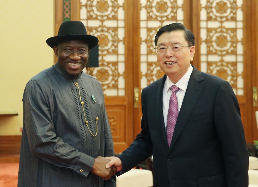Zhang Dejiang (R), chairman of the Standing Committee of the National People's Congress of China, shakes hands with Nigerian President Goodluck Ebele Jonathan during their meeting in Beijing, capital of China, July 11, 2013. (Xinhua/Yao Dawei)