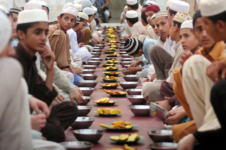 Pakistani Muslims wait for taking Iftar at a mosque during the first day of the Muslim fasting month of Ramadan in northwest Pakistan's Peshawar on July 11, 2013. Iftar refers to the evening meal when Muslims break their fast during the holly month of Ramadan, a season of fasting and spiritual reflection. (Xinhua/Umar Qayyum)