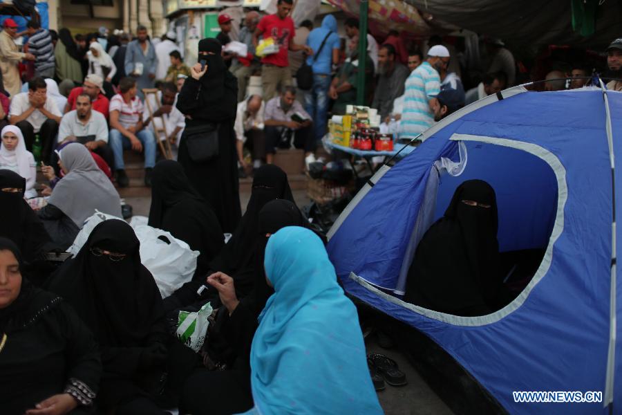 Female supporters of ousted Egyptian President Mohamed Morsi attend a protest near the Rabaa al-Adawiya mosque, in Cairo, Egypt, July 12, 2013. (Xinhua/Wissam Nassar) 