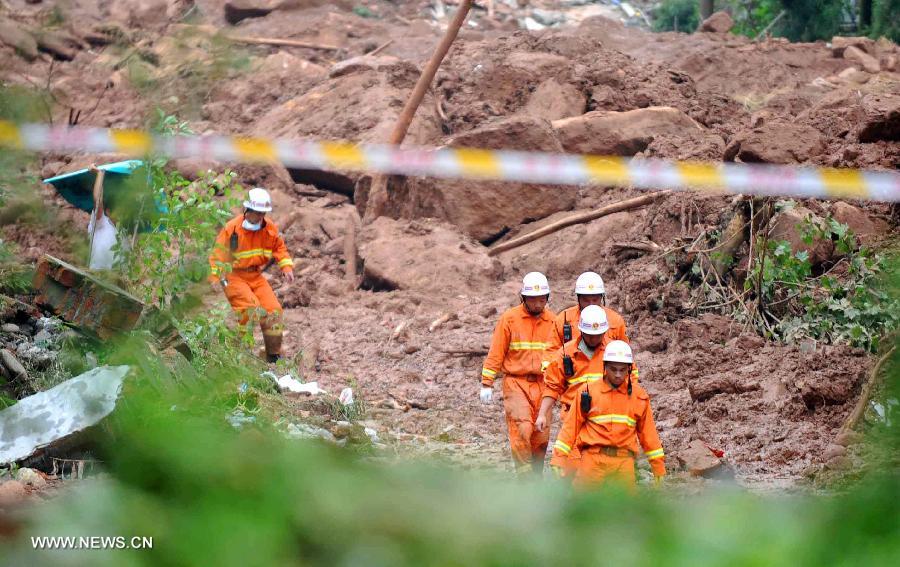 Firefighters search for survivors at the landslide scene in Sanxi Village of Dujiangyan City, southwest China's Sichuan Province, July 13, 2013. As of 19:00 p.m. (GMT 1100), 43 people were confirmed dead during the landslide that happened in the village of Sanxi on July 10. Some 118 people across the city were missing or can not immediately be reached. Local authorities are continuing to verify the exact number of those missing. Search and rescue work continues. (Xinhua/Xue Yubin)