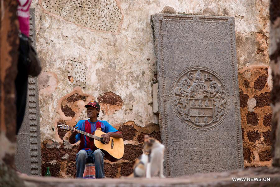 A man plays guitar at the site of St Paul's Church in Melaka, Malaysia, July 12, 2013. Melaka and George Town, historic cities of the Straits of Malacca, were inscribed onto the list of UNESCO World Heritage Site in July 2008. (Xinhua/Chong Voon Chung)