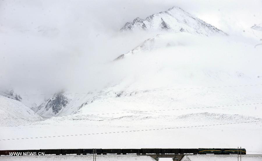 A freight train runs past the Kunlun Mountain on the Qinghai-Tibet Railway in northwest China's Qinghai Province July 9, 2013. Within seven years after its operation, the Qinghai-Tibet Railway, the longest and highest railway in the world, has carried nearly 64 million passengers and 300 million tonnes of goods. (Xinhua/Hou Deqiang)