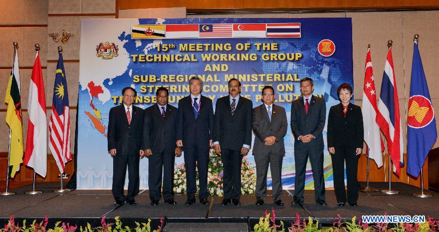 Ministers of the Association of Southeast Asian Nations (ASEAN) countries pose for photos together with ASEAN Secretary-General Le Luong Minh (1st L) during the 15th Ministerial Steering Committee Meeting on Transboundary Haze Pollution in Kuala Lumpur, Malaysia, on July 17, 2013. Officials from the haze-inflicted Southeast Asian countries tried to make joint effort to end the heavy smog that troubles the region despite differences at a ministerial meeting here on Wednesday. (Xinhua/Chong Voon Chung)
