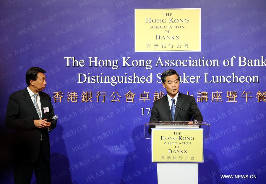 Hong Kong Chief Executive C Y Leung (R) answers questions from media after he addressed a luncheon held by the Hong Kong Association of Banks in south China's Hong Kong, July 17, 2013. Leung said despite the global financial crisis, Hong Kong's banking sector continues to be the driving force in deepening, expanding and diversifying financial services in the city. (Xinhua/Li Peng)