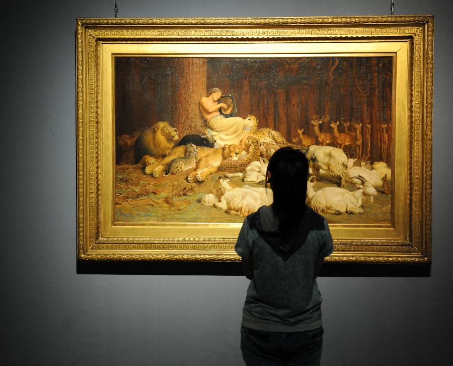 A woman looks at a painting with her cellphone at an exhibition displaying works of art from public collection in northwest England in Zhengzhou, capital of central China's Henan Province, July 21, 2013. Many local citizens spent their weekends by visiting the exhibition, which lasts from June 25, 2013 to Aug. 9, 2013 at Henan Museum. (Xinhua/Li Bo)
