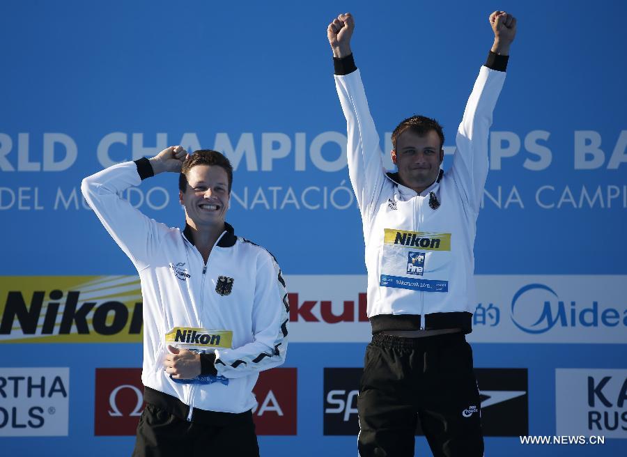 Germany's Sascha Klein (R) and Patrick Hausding celebrate during the awarding ceremony after the men's 10m synchro platform final of the Diving competition in the 15th FINA World Championships at the Piscina Municipal de Montjuic in Barcelona, Spain, on July 21, 2013. Sascha Klein and Patrick Hausding claimed the title with a total socre of 461.46 points. (Xinhua/Wang Lili)
