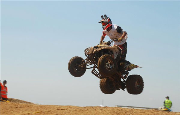 A rider jumps his vehicle during the China ATVs and International Invitational Tournament on July 21, 2013 in Dongying city, Shandong province.(Source:China Daily/ Photo:Xinhua)