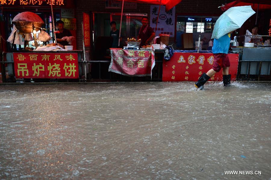 Shunyu Road is waterlogged in Jinan, capital of east China's Shandong Province, July 23, 2013. A heavy rainfall hit Jinan on Tuesday. (Xinhua/Guo Xulei)