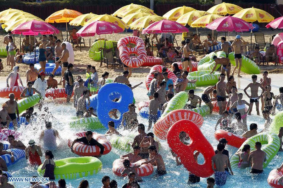 Residents play in a water park in east China's Shanghai, July 24. The highest temperature reached 40.8 degrees Celsius in some areas of Shanghai on Wednesday. (Xinhua/Ding Ting) 