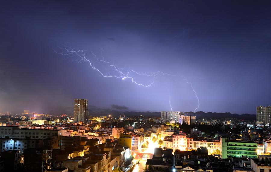 Lightning is seen over the county seat of Luoping in southwest China's Yunnan Province, July 26, 2013. A heavy rainfall hit Luoping County on Friday. (Xinhua/Mao Hong)