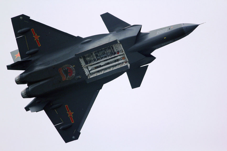 A clear view of the 2nd prototype J20 flying low with weapons bay open. The configuration shown here carries four radar-guided Beyond Visual Range air/air missiles. Additional weapons bays on the fuselage sides can also carry similar weapons or passive, heat-seeking AAMs.(Source: huanqiu.com)