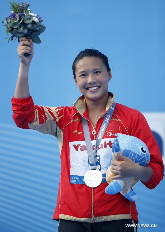 China's Wang Han reacts during the awarding ceremony for Women's 3m Springboard diving at the 15th FINA World Championships in Barcelona, Spain, on July 27, 2013. Wang Han took the silver medal with a total score of 356.25 points. (Xinhua/Wang Lili) 
