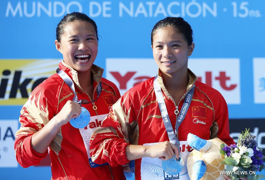China's He Zi (R) and Wang Han react during the awarding ceremony for Women's 3m Springboard diving at the 15th FINA World Championships in Barcelona, Spain, on July 27, 2013. He Zi claimed the title with a total score of 383.40 points while Wang Han took the silver medal. (Xinhua/Wang Lili) 