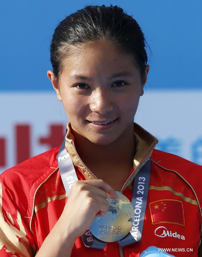 China's He Zi shows her gold medal during the awarding ceremony for Women's 3m Springboard diving at the 15th FINA World Championships in Barcelona, Spain, on July 27, 2013. He Zi claimed the title with a total score of 383.40 points. (Xinhua/Wang Lili) 