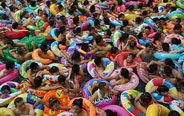 People cram in water pool to cool off