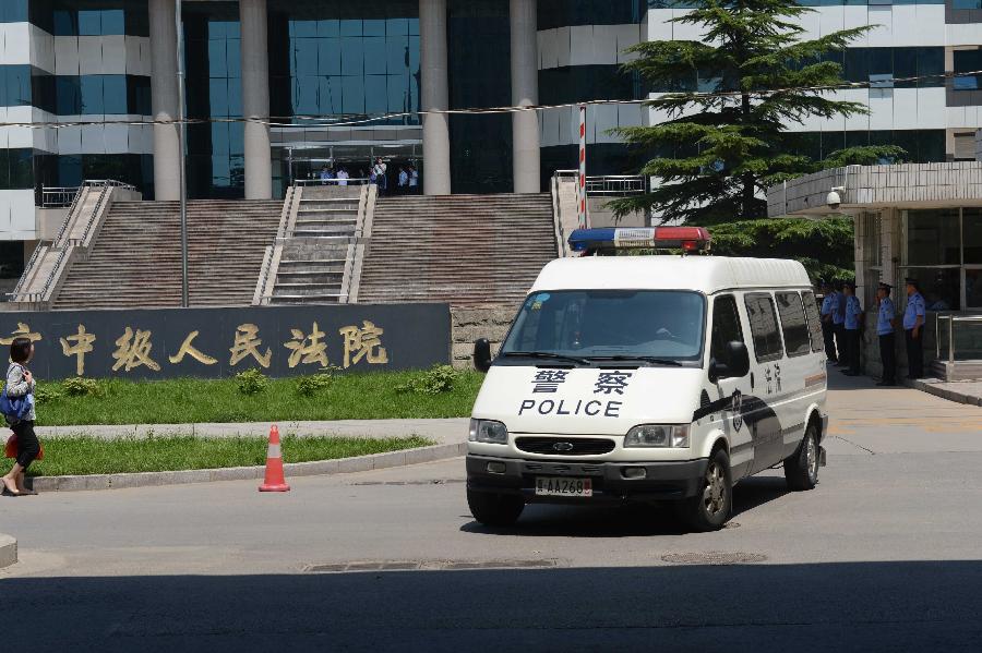 A police car drives out of the Shijiazhuang Intermediate People's Court after the trial in Shijiazhuang, north China's Hebei Province, July 30, 2013. The court on Tuesday opened a trial for a man who allegedly added poison to frozen dumplings that sickened four Chinese and nine Japanese citizens in 2008. (Xinhua/Wang Min) 