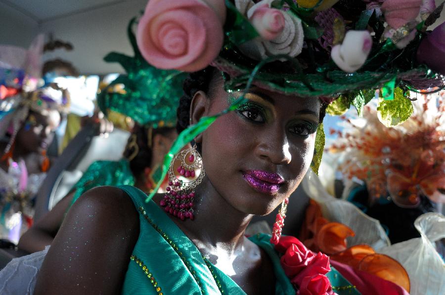 A member of a Hatian group participates in the Carnival of the Flowers of Haiti, in Port au Prince downtown, capital of Haiti, on July 31, 2013. Carnival of the Flowers of Haiti second edition, which convened thousands of people, bands, floats and costumed groups, was closed on Wednesday in the Haitian capital. (Xinhua/Swoan Parker)
