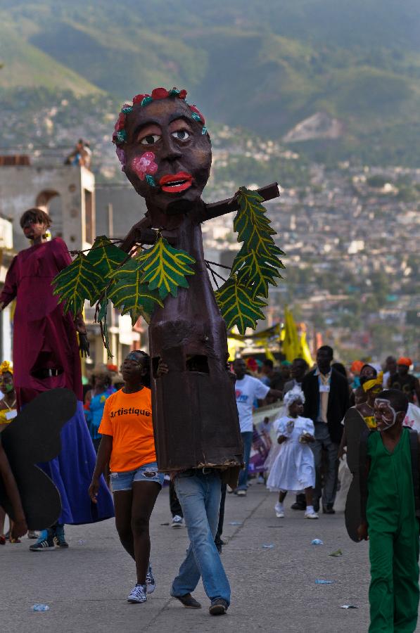 Members of a Haitian group participate with colirful costumes in the Carnival of the Flowers of Haiti, in Port au Prince downtown, capital of Haiti, on July 31, 2013. Carnival of the Flowers of Haiti second edition, which convened thousands of people, bands, floats and costumed groups, was closed on Wednesday in the Haitian capital. (Xinhua/Swoan Parker)