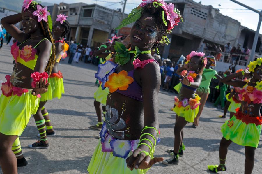 Members of a Haitian group participate in the Carnival of the Flowers of Haiti, in Port au Prince downtown, capital of Haiti, on July 31, 2013. Carnival of the Flowers of Haiti second edition, which convened thousands of people, bands, floats and costumed groups, was closed on Wednesday in the Haitian capital. (Xinhua/Swoan Parker)