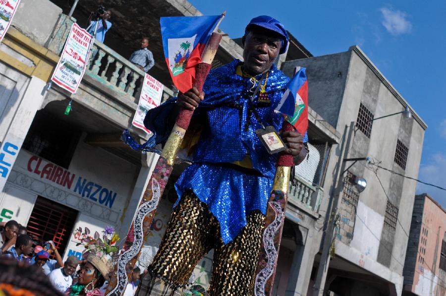 A Haitian reveler participates in the Carnival of the Flowers of Haiti, in Port au Prince downtown, capital of Haiti, on July 31, 2013. Carnival of the Flowers of Haiti second edition, which convened thousands of people, bands, floats and costumed groups, was closed on Wednesday in the Haitian capital. (Xinhua/Swoan Parker)