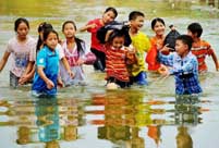 Students wade through water to school